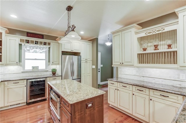 kitchen with appliances with stainless steel finishes, pendant lighting, beverage cooler, backsplash, and light stone counters