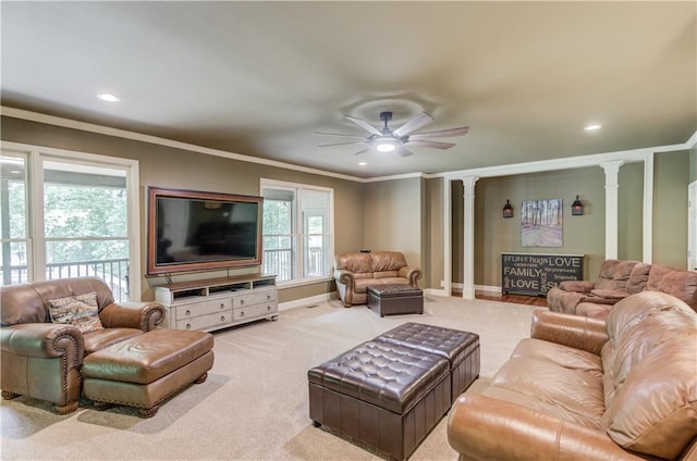 carpeted living room featuring decorative columns, ornamental molding, a wealth of natural light, and ceiling fan