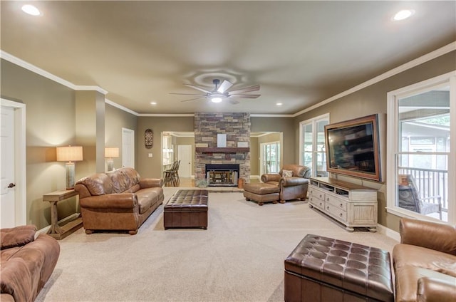 living room with crown molding, light colored carpet, a fireplace, and ceiling fan