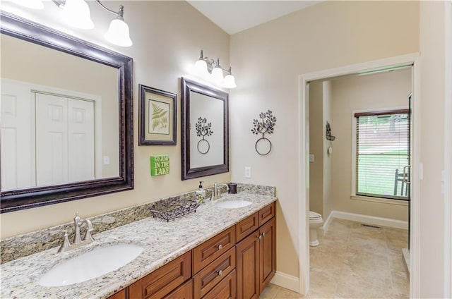 bathroom featuring vanity, tile patterned floors, and toilet