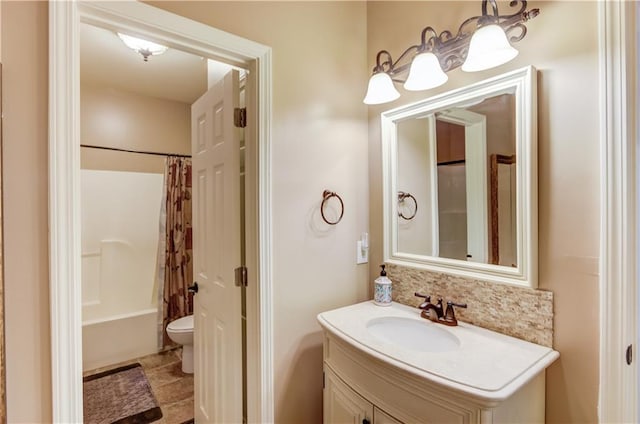 full bathroom featuring tasteful backsplash, vanity, toilet, and shower / bath combo with shower curtain