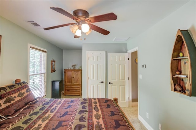 bedroom with light carpet, ceiling fan, and a closet