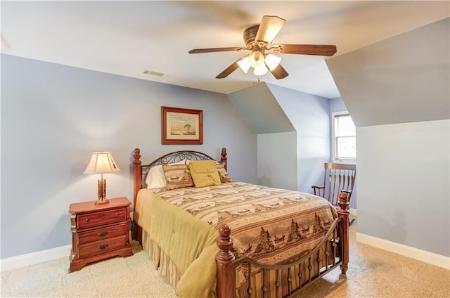 carpeted bedroom with vaulted ceiling and ceiling fan