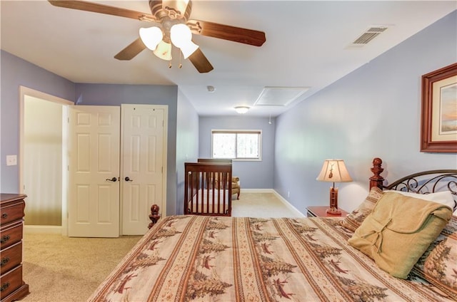 bedroom featuring ceiling fan, light colored carpet, and a closet