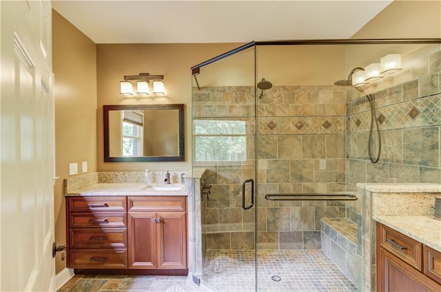 bathroom with vanity and a shower with door
