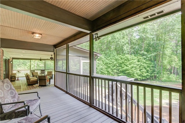 sunroom featuring beamed ceiling