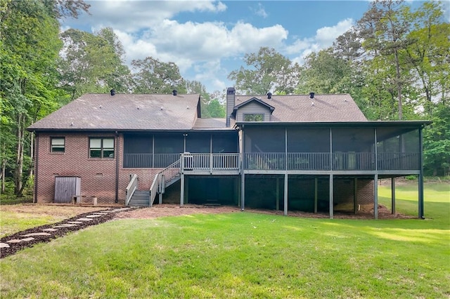back of property featuring a lawn and a sunroom