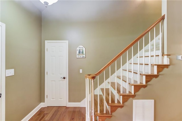staircase featuring hardwood / wood-style floors