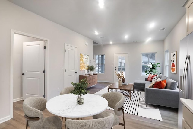 dining area featuring light wood-style flooring, recessed lighting, and baseboards