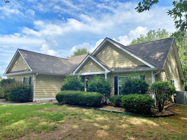 view of front of home featuring cooling unit and a front lawn