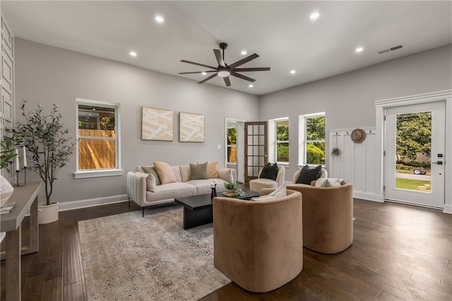 living room with ceiling fan and dark hardwood / wood-style floors