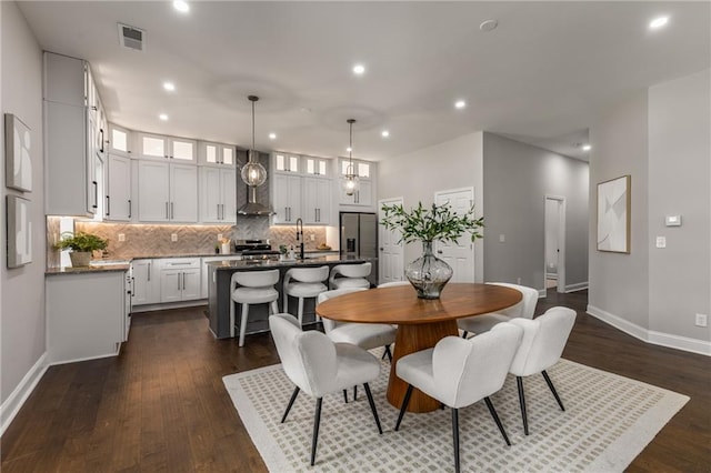 dining space with dark wood-type flooring and sink