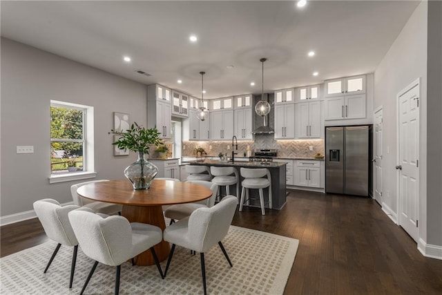 dining space featuring sink and dark hardwood / wood-style flooring