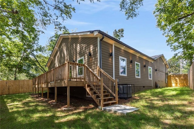 rear view of house featuring a yard and a wooden deck