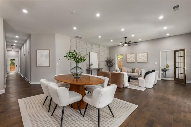 dining space with ceiling fan and dark wood-type flooring