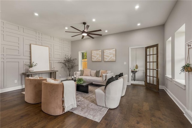 living room with ceiling fan and dark hardwood / wood-style flooring