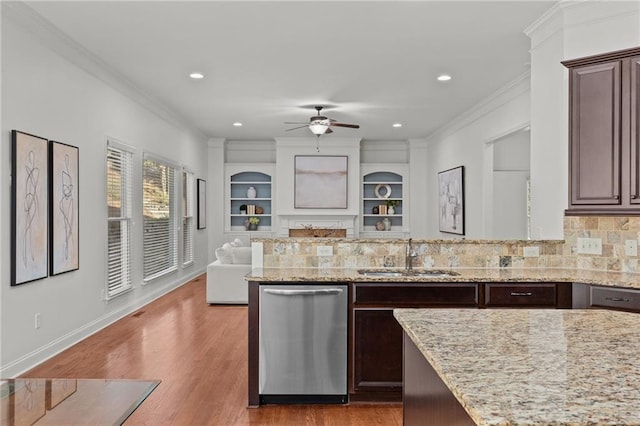 kitchen featuring stainless steel dishwasher, ornamental molding, sink, and dark brown cabinets