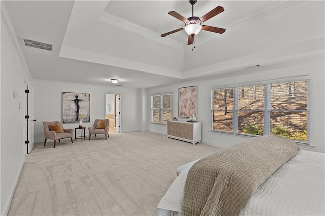 carpeted bedroom featuring crown molding, ceiling fan, and a tray ceiling