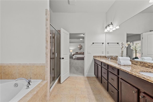 bathroom with vanity and shower with separate bathtub