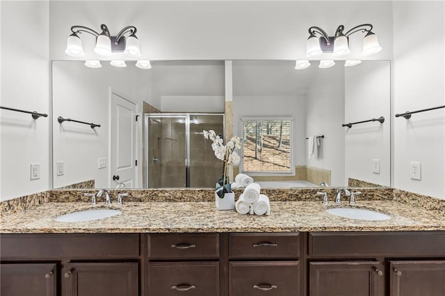 bathroom featuring vanity and a shower with door