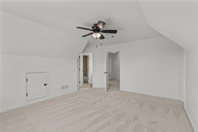 bonus room with vaulted ceiling, light colored carpet, and ceiling fan