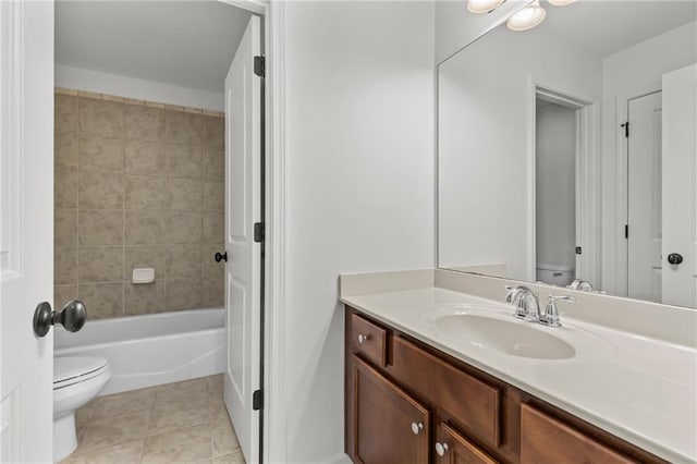 full bathroom featuring vanity, tiled shower / bath, tile patterned floors, and toilet