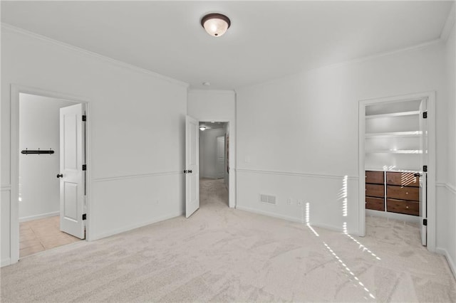 unfurnished bedroom with ornamental molding and light carpet