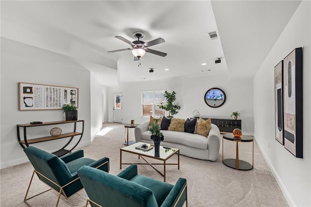 living room featuring light colored carpet and ceiling fan