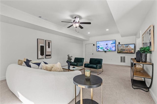 carpeted living room featuring ceiling fan and ornamental molding