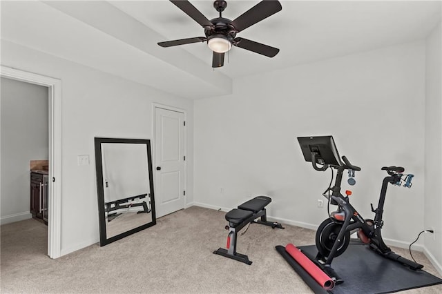 workout area featuring light carpet and ceiling fan