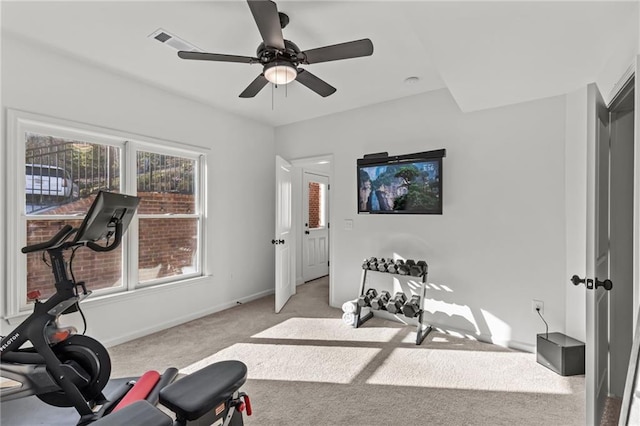 workout area with ceiling fan and light carpet