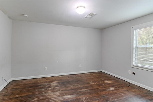 empty room with dark wood-type flooring