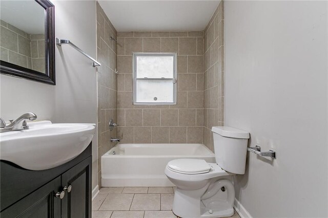 full bathroom featuring tile patterned flooring, vanity, toilet, and tiled shower / bath combo