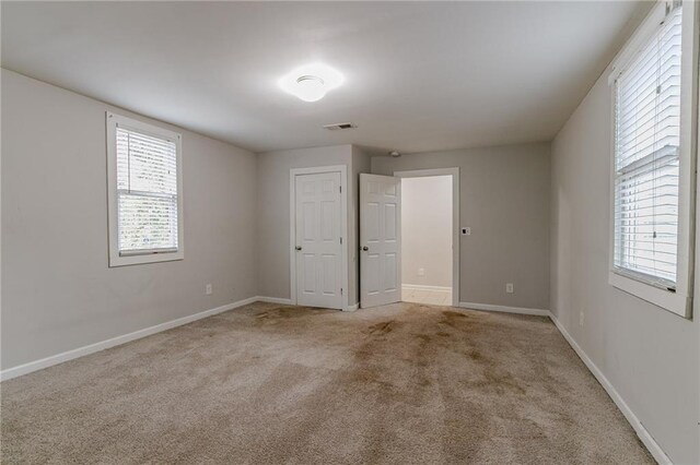 unfurnished bedroom featuring light colored carpet