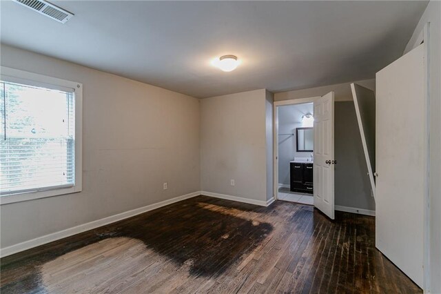 unfurnished room with dark hardwood / wood-style flooring