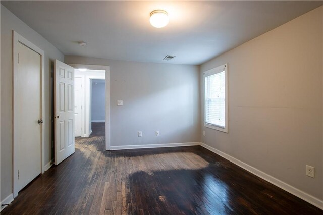 unfurnished room featuring dark hardwood / wood-style flooring