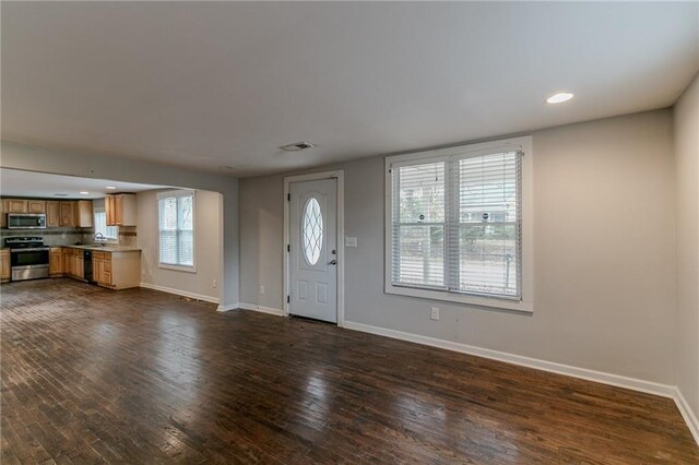 foyer with dark hardwood / wood-style floors and sink