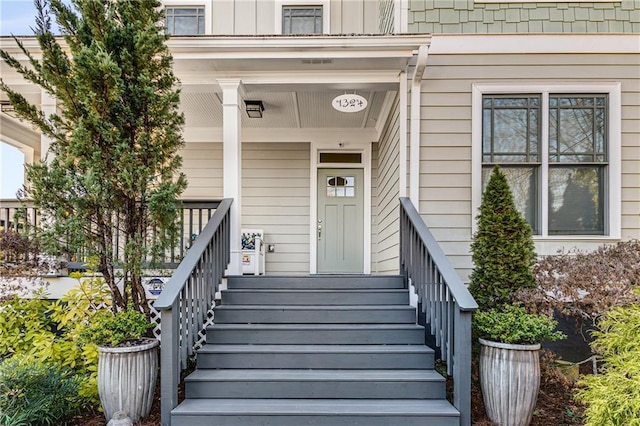 property entrance with a porch and board and batten siding