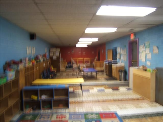 interior space with a paneled ceiling