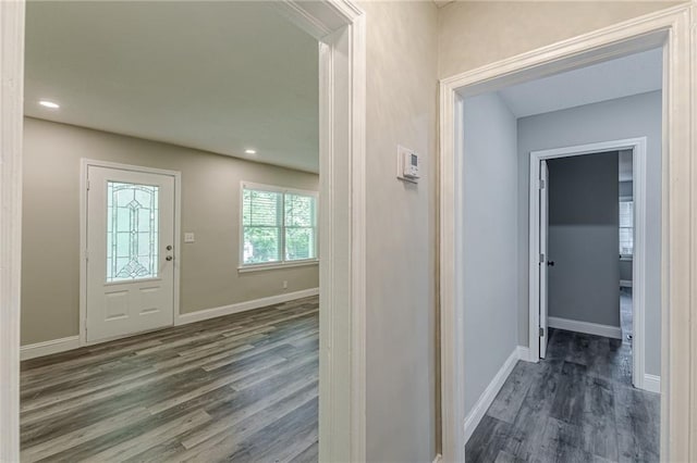 foyer entrance featuring baseboards, wood finished floors, and recessed lighting