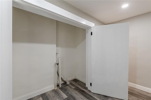 washroom featuring baseboards, wood finished floors, laundry area, and recessed lighting