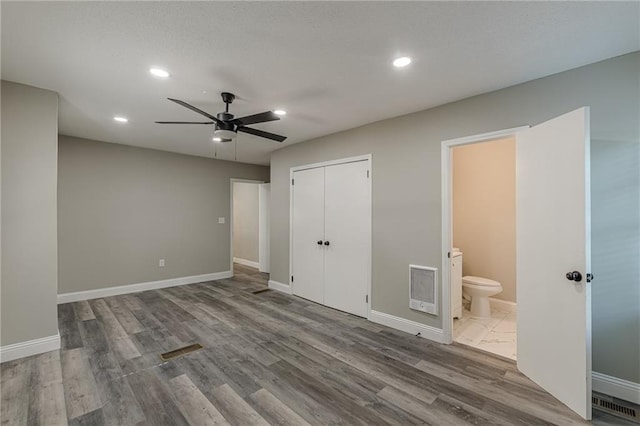unfurnished bedroom with baseboards, wood finished floors, and recessed lighting