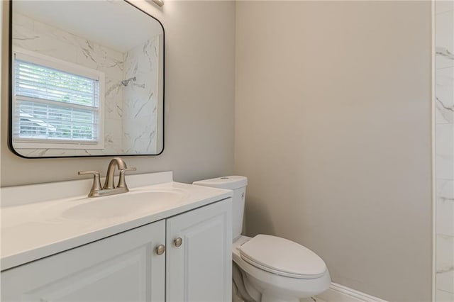 bathroom featuring toilet and vanity