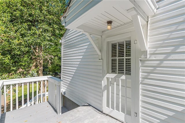view of exterior entry with a deck