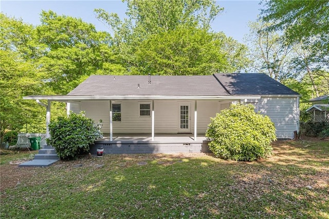 back of property with a yard, crawl space, and covered porch
