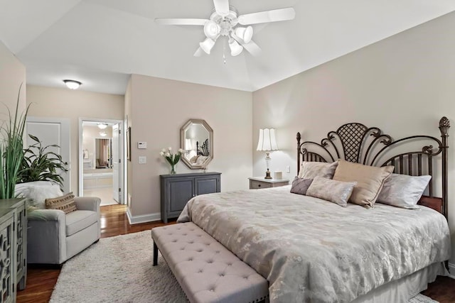 bedroom with dark wood-type flooring, connected bathroom, and ceiling fan