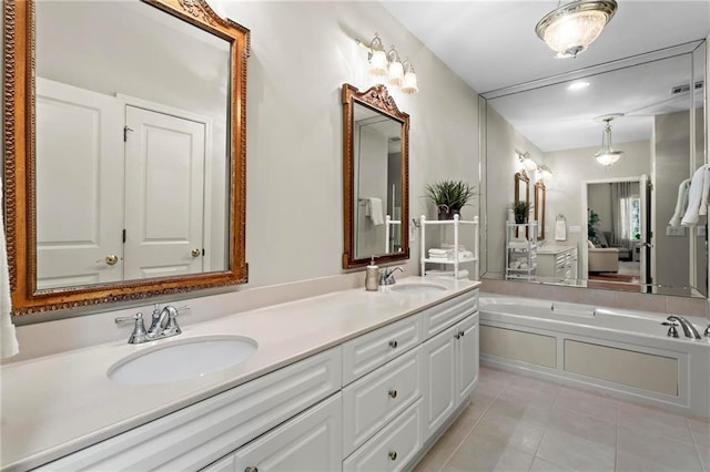 bathroom featuring tile patterned flooring, vanity, and a bath