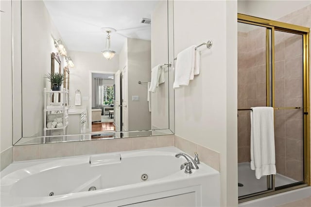 bathroom with separate shower and tub