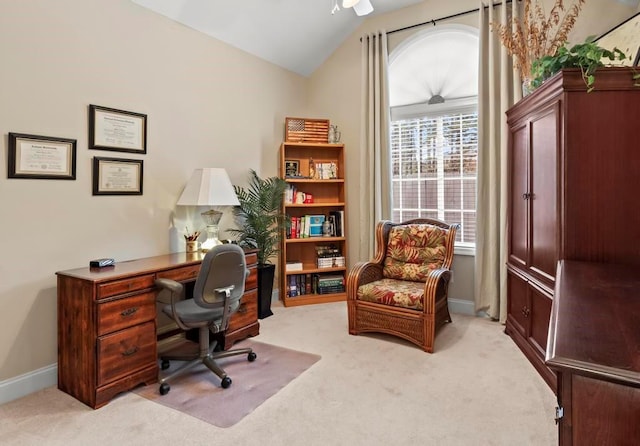 carpeted home office featuring vaulted ceiling