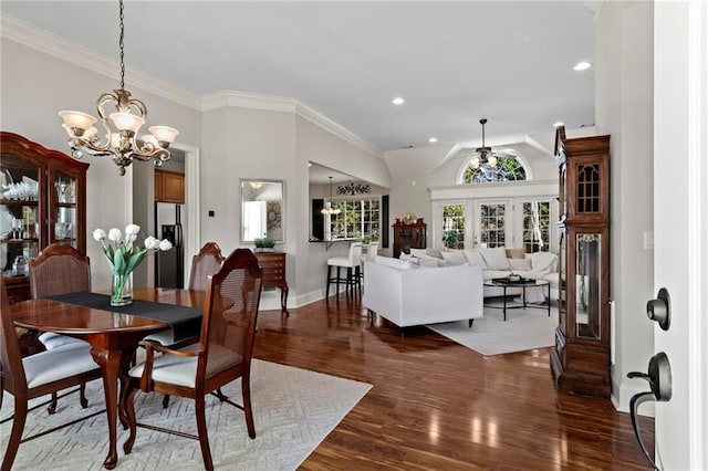 dining space featuring a notable chandelier, crown molding, and dark hardwood / wood-style floors